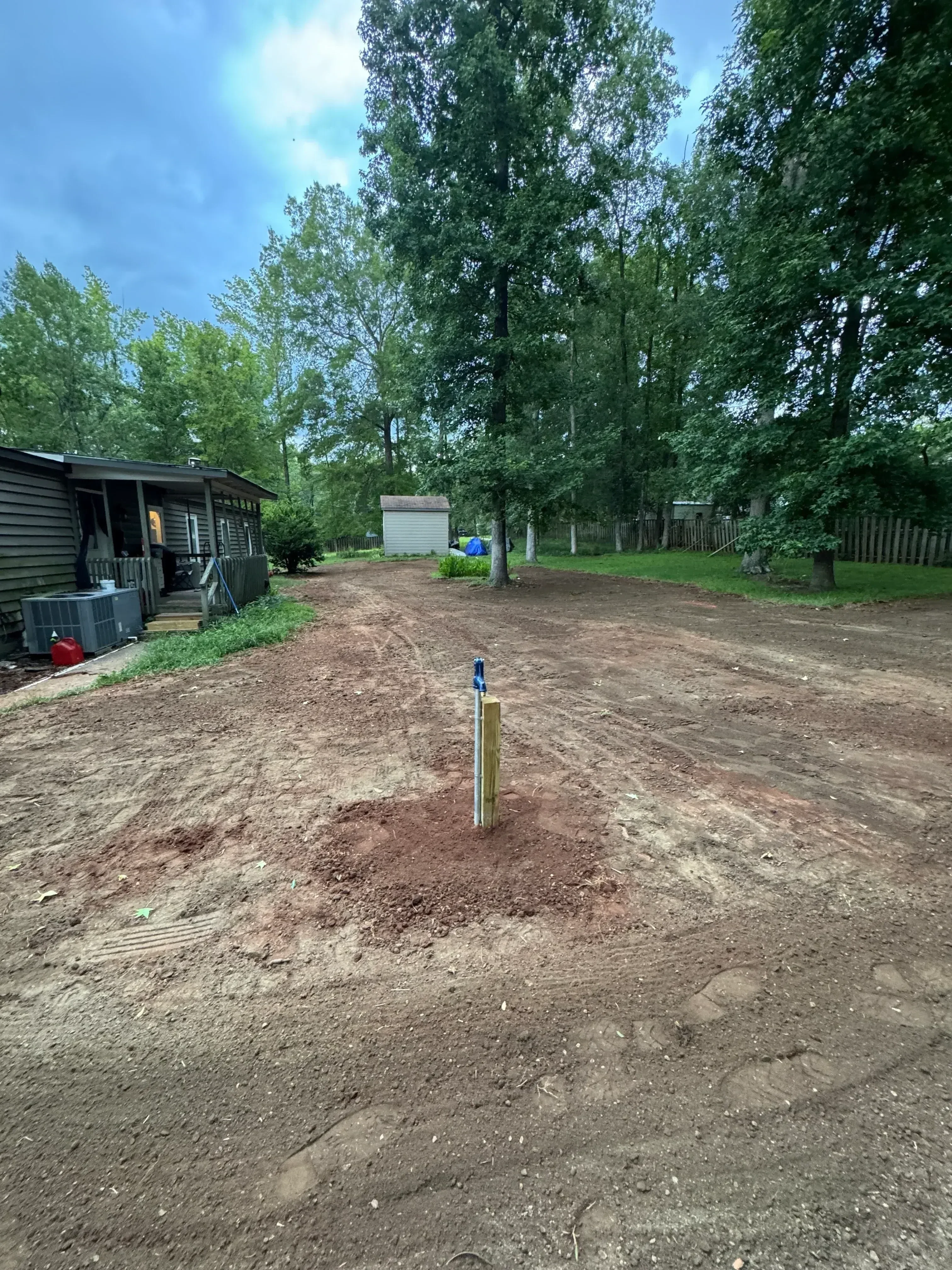 Demolished residential lot with cleared earth and removed foundation debris